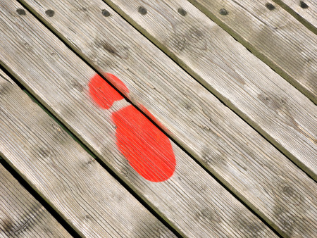 Red Painted footprint on Southwold Pierの写真素材