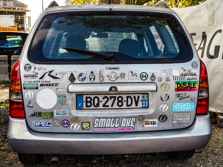 Old Car in Bordeaux Covered in a Multitude of Stickersのeditorial素材