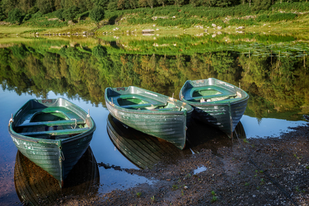Rowing Boats Moored at Watendlath Tarn in the Lake District Cumbriaの写真素材