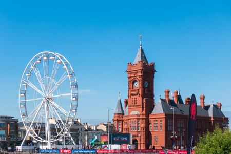 CARDIFF/UK - AUGUST 27 : Ferris Wheel and Pierhead Building in Cardiff on August 27, 2017. Unidentified peopleのeditorial素材
