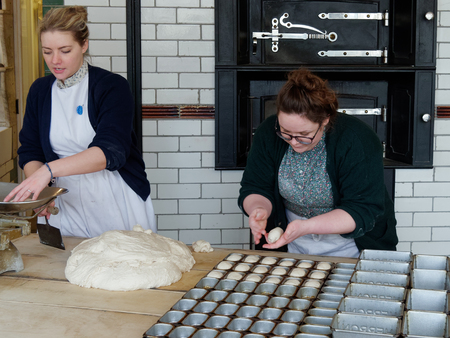 STANLEY, COUNTY DURHAM/UK - JANUARY 20 : Two women working in an old bakery at the North of England Open Air Museum in Stanley, County Durham on January 20, 2018. Unidentified womenのeditorial素材