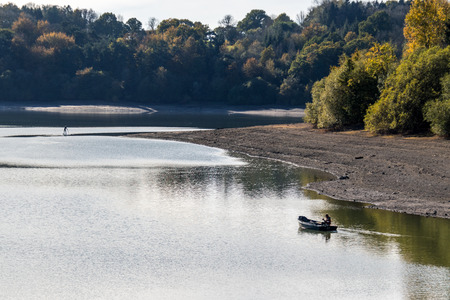 ARDINGLY, SUSSEX/UK - NOVEMBER 2 : Man fishing at the reservoir in Ardingly Sussex on November 2, 2018. Two unidentified peopleの写真素材