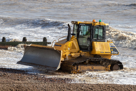 WORTHING, WEST SUSSEX/UK - NOVEMBER 13 : Bulldozer repairing sea defences in Worthing West Sussex on November 13, 2018. Unidentified people.のeditorial素材