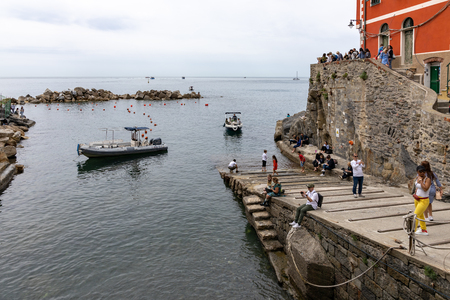 RIOMAGGIORE, LIGURIA/ITALY  - APRIL 21 : People by the sea in Riomaggiore Liguria Italy on April 21, 2019. Unidentified peopleのeditorial素材
