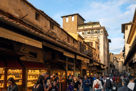 FLORENCE, TUSCANY/ITALY - OCTOBER 18 : View of buildings and people on Ponte Vecchio bridge in Florence on October 18, 2019. Unidentified people.のeditorial素材