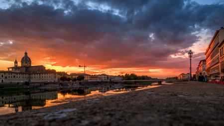 FLORENCE, TUSCANY/ITALY - OCTOBER 19 : View of buildings along the River Arno at dusk  in Florence  on October 19, 2019. Unidentified peopleのeditorial素材