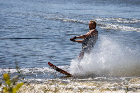 FELBRIDGE, SURREY/UK - AUGUST 2 : Water skiing at Wiremill Lake near Felbridge Surrey on August 2, 2020. One unidentifed manのeditorial素材