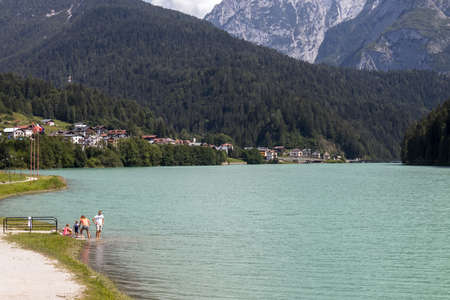 AURONZO DI CADORE, VENETO/ITALY - AUGUST 9 : View of Santa Caterina Lake at Auronzo di Cadore, Veneto, Italy on August 9, 2020. Four unidentified peopleのeditorial素材