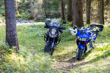 TONDICO, TRENTINO/ITALY - AUGUST 11 : Two motorbikes parked in the Natural Park of Paneveggio Pale di San Martino in Tonadico, Trentino, Italy on August 11, 2020のeditorial素材