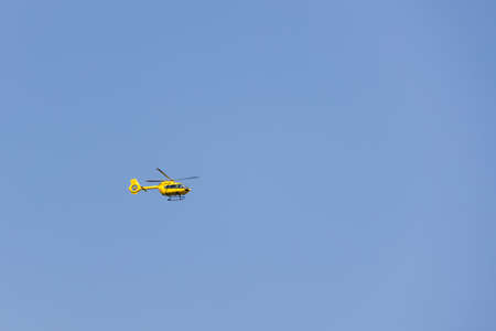 TORRE DE ROVERI, LOMBARDY/ITALY - AUGUST 13 : Yellow helicopter flying over Torre de' Roveri, Lombardy, Italy on August 13, 2020のeditorial素材