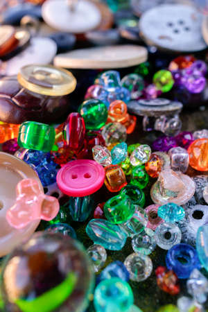 A group of randomly scattered beads, buttons and marblesの写真素材