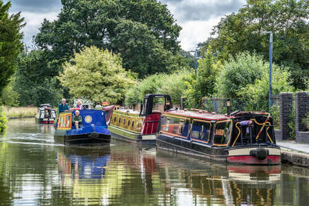 ELLESMERE, SHROPSHIRE, UK - JULY 12 : Narrow boats in Ellesmere, Shropshire on July 12, 2021. Three unidentified peopleのeditorial素材