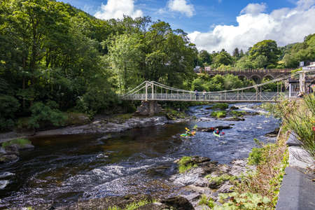 BERWYN, DENBIGHSHIRE, WALES - JULY 11 : People kayaking by the Chainbridge in Berwyn, Wales on July...