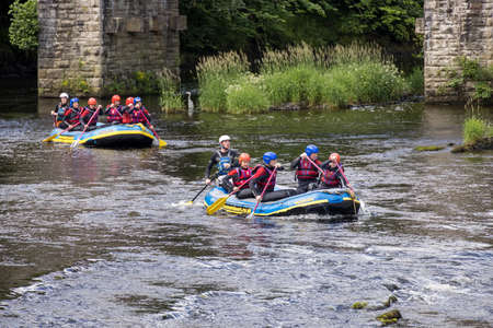 BERWYN, DENBIGHSHIRE, WALES - JULY 11 : People white water rafting on the River Dee in Berwyn, Wales...