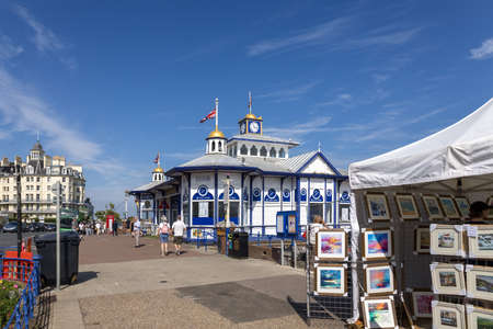 EASTBOURNE, EAST SUSSEX, UK - JULY 29 : View along the promenade towards Eastbourne Pier in East Sussex on July 29 2021. Unidentified peopleのeditorial素材