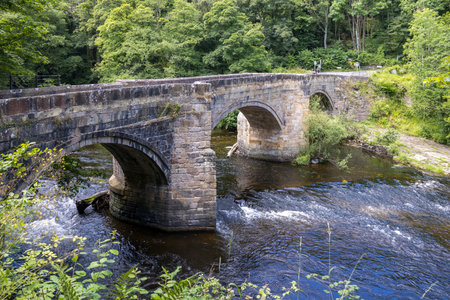 FRONCYSYLLTE, WREXHAM, WALES - JULY 15 : Stone bridge over the River Dee near Pontcysyllte Aqueduct, Froncysyllte, Wrexham, Wales, UK on July 15, 2021. One unidentified peopleのeditorial素材