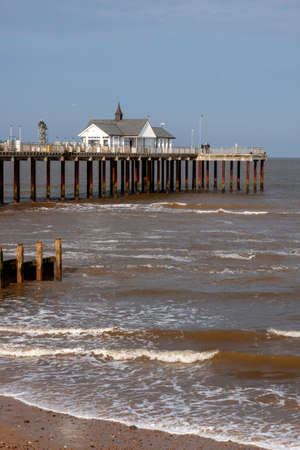 SOUTHWOLD, SUFFOLK, UK - MAY 31 : Sun setting over Southwold Pier Suffolk on May 31, 2010. Four unidentified people.のeditorial素材