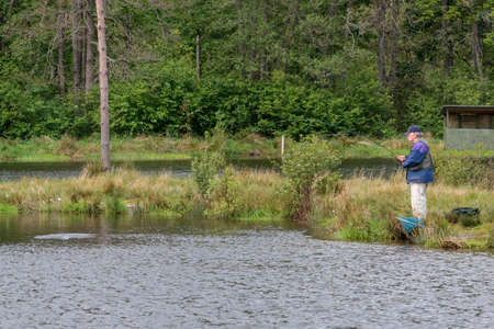 RIVER FINDHORN, SCOTLAND -  MAY 18 : Fly fishing on the Findhorn River, Scotland on May 18, 2011.. Unidentfied manのeditorial素材