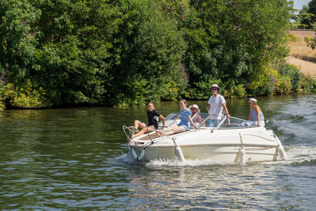Thames Ditton Surrey, UK - July 15, 2022 : People cruising along the River Thames at Thames Ditton on July 15, 2022. Unidentified peopleのeditorial素材