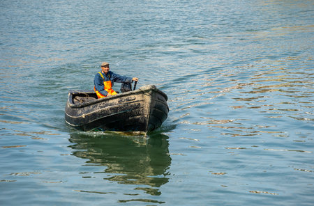 SCARBOROUGH,  NORTH YORKSHIRE, UK - JULY 18: Man in small fishing boat in Scarborough, North Yorkshire on July 18, 2022. Unidentified manのeditorial素材