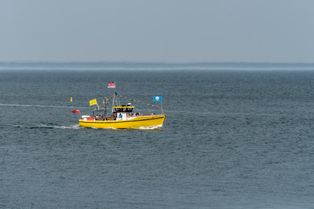 WHITBY,  NORTH YORKSHIRE, UK - JULY 19: Pleasure boat heading towards Whitby, North Yorkshire on...