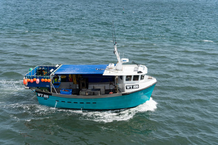 WHITBY,  NORTH YORKSHIRE, UK - JULY 19: Fshing boat heading towards Whitby, North Yorkshire on July 19, 2022. One unidentified personのeditorial素材
