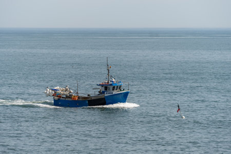 SCARBOROUGH,  NORTH YORKSHIRE, UK - JULY 18: Fshing boat heading towards Scarborough, North Yorkshire on July 18, 2022のeditorial素材