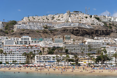 PUERTO RICO, GRAN CANARIA, CANARY ISLANDS - MARCH 9 : View of the beach in Puerto Rico Gran Canaria on March 9, 2022. Unidentified peopleのeditorial素材
