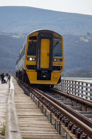 BARMOUTH, GWYNEDD UK - APRIL 09 : Train travelling over the viaduct in Barmouth, Gwynedd on April...