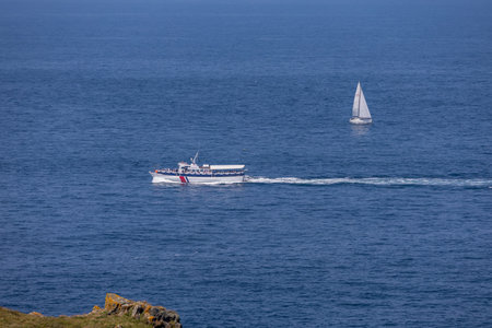 Trevose Head, Cornwall, UK - June 15.  Yacht and motor launch off Trevose Head in Cornwall on June 15, 2023のeditorial素材