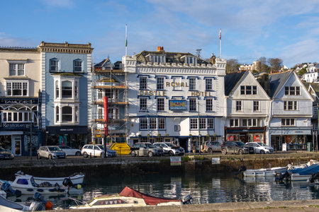 Dartmouth, Devon, UK - January 14. Old traditional buildings around the harbour in Dartmouth, Devon on January 14, 2024. Four unidentified peopleのeditorial素材