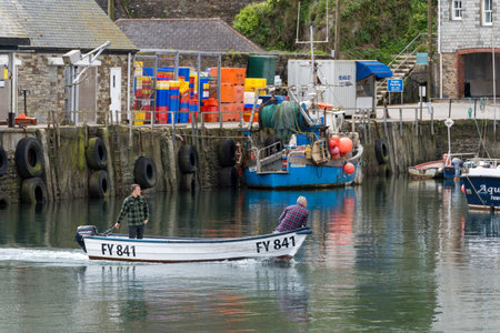 MEVAGISSEY, CORNWALL, UK, MAY 3. View of Mevagissey harbour in Cornwall on May 3, 2024. Two...