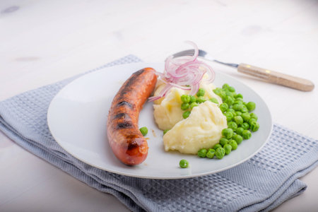 Sausages with mash and some peas and onionsの写真素材