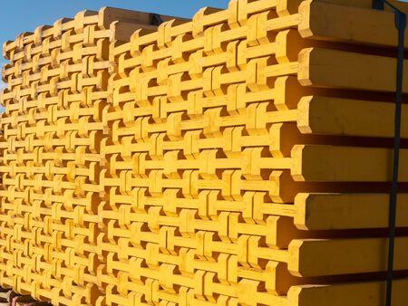 Yellow wooden piled formwork beams. Construction equipment.の写真素材