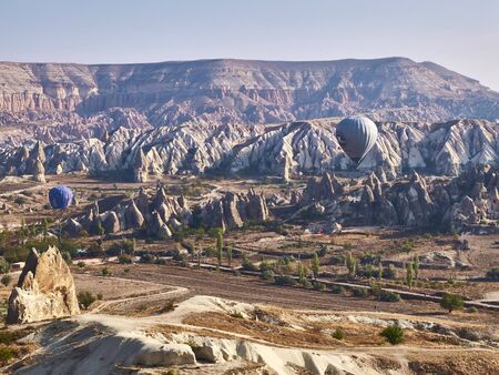 Goreme National Park, Cappadocia, Turkey - October 2019. Colorful hot air balloons in the sunny autumn morning.のeditorial素材