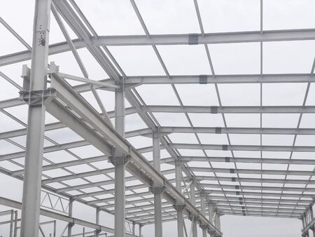Metal frame of prefabricated multi-storey building. Metal pillars, beams and diagonal bracings