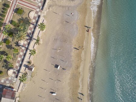 Aerial view of sandy beach and seaside promenade.の写真素材