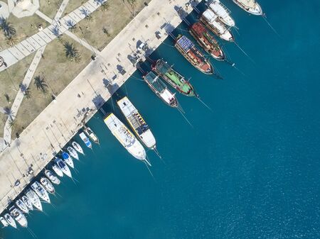 Top view of yachts moored in marina.