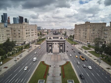 Moscow, Russia - June 2019. Triumphal arch, Moscow City IBC and Stalinism residential buildings on Kutuzovskiy avenue. Aerial viewのeditorial素材