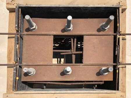 Formwork and reinforcement of concrete reinforced foundation with metal anchor bolts designed for...