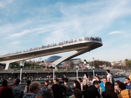 Moscow, Russia - May 2018. People on the hanging bridge in Zaryadye Park and people on the deck of river boat.のeditorial素材