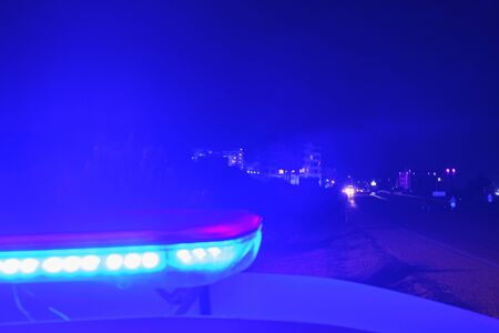 police car flashing lights in the night selective focus.
