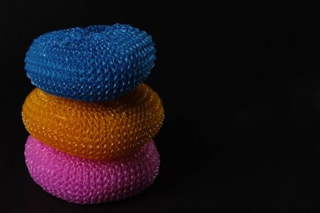 Set of colorful dish washing sponges at black background.