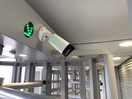IP camera and green arrow indicator on turnstile.