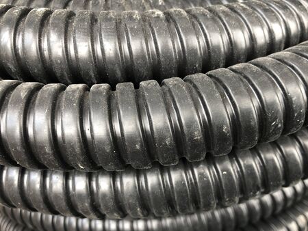black coiled corrugated insulation tube at warehouse.の写真素材