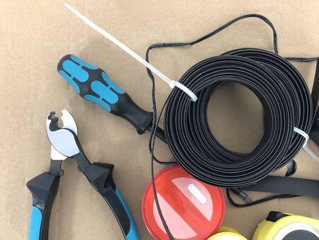Cutting pliers screwdriver and other wiring tools cardboard copy space.