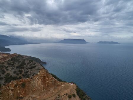 Heavy rain clouds above gulf and dirt roads. aerial view.の写真素材