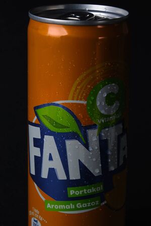 Mersin, Turkey - February 2020. Chilled Fanta can with water drops and inscriptions on Turkish at black background.のeditorial素材