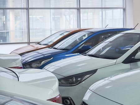 New multicolored sedan cars in the car showroom.の写真素材
