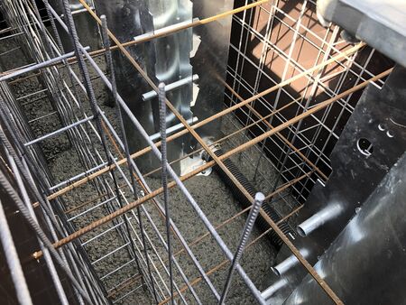 Pouring concrete to road bollard formwork foundation.